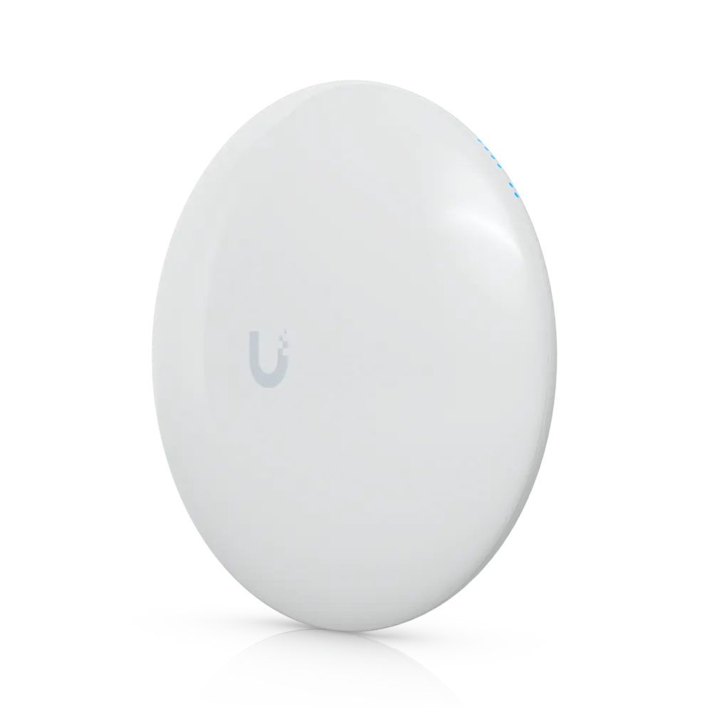 White, round Ubiquiti wireless bridge radio with the Ubiquiti logo on its face