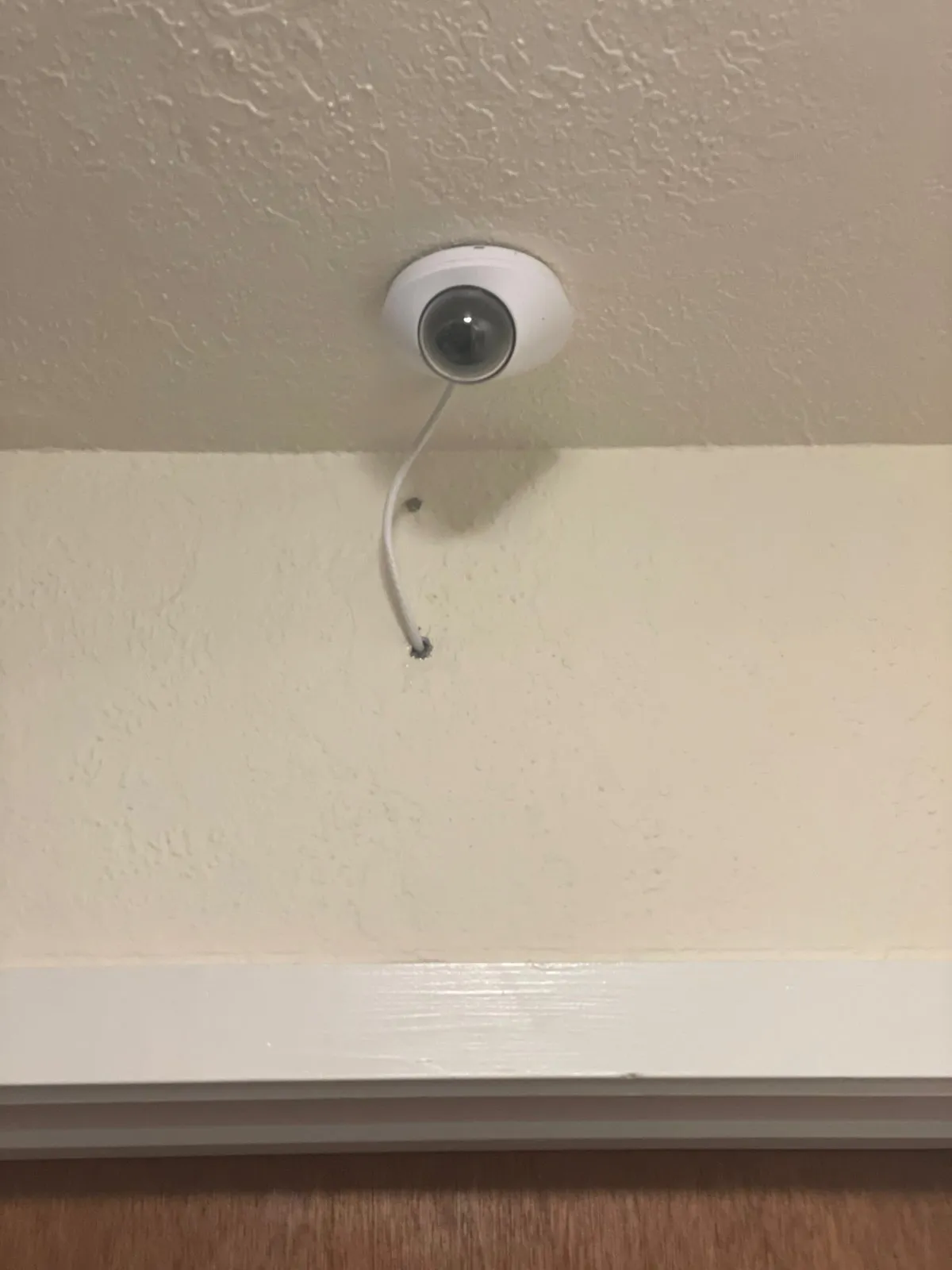 Dome security camera installed on an interior ceiling