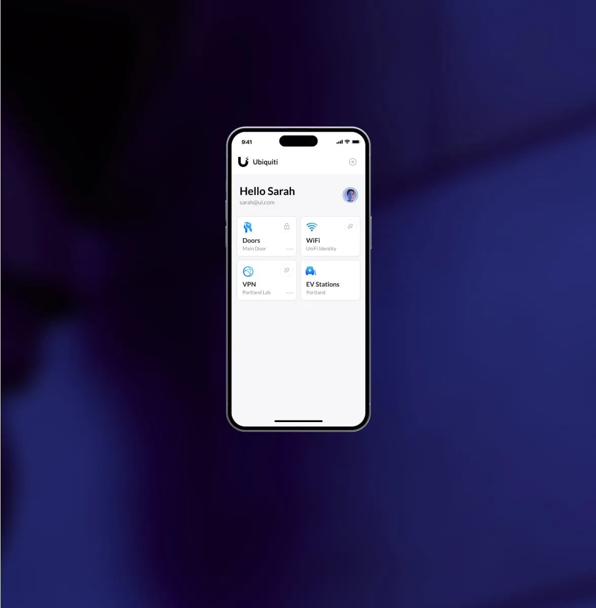 Phone showing the UniFi Identity app with shortcuts for doors, Wi-Fi, VPN and EV stations