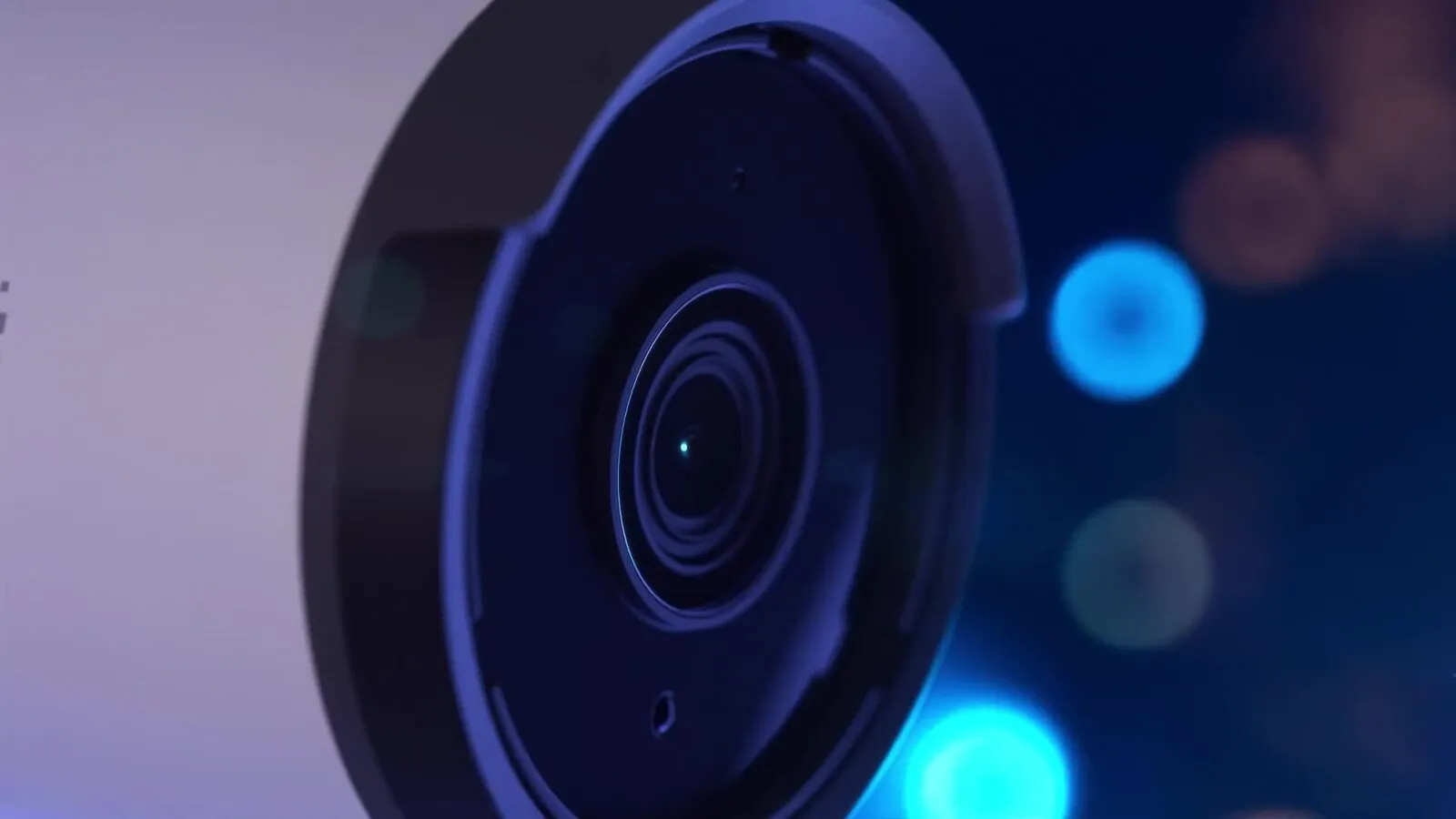 Close-up of a UniFi camera lens against a dark blue background